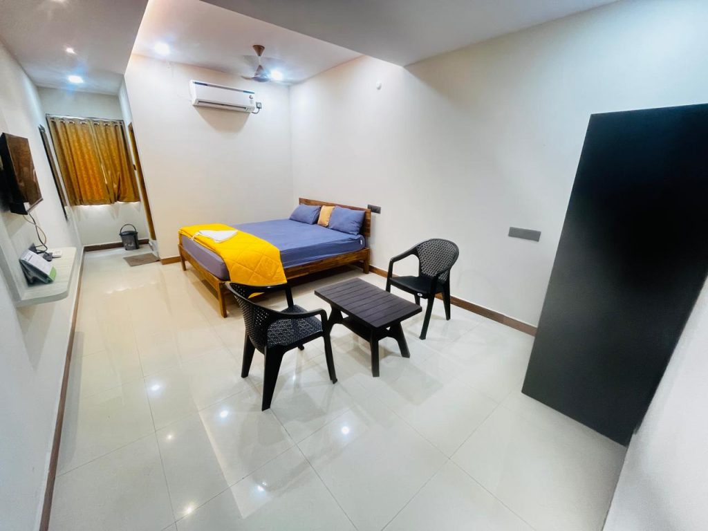 A clean and modern AC Deluxe Room at Raaj Hotel, designed for a comfortable stay in Nacharam.