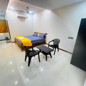 A clean and modern AC Deluxe Room at Raaj Hotel, designed for a comfortable stay in Nacharam.