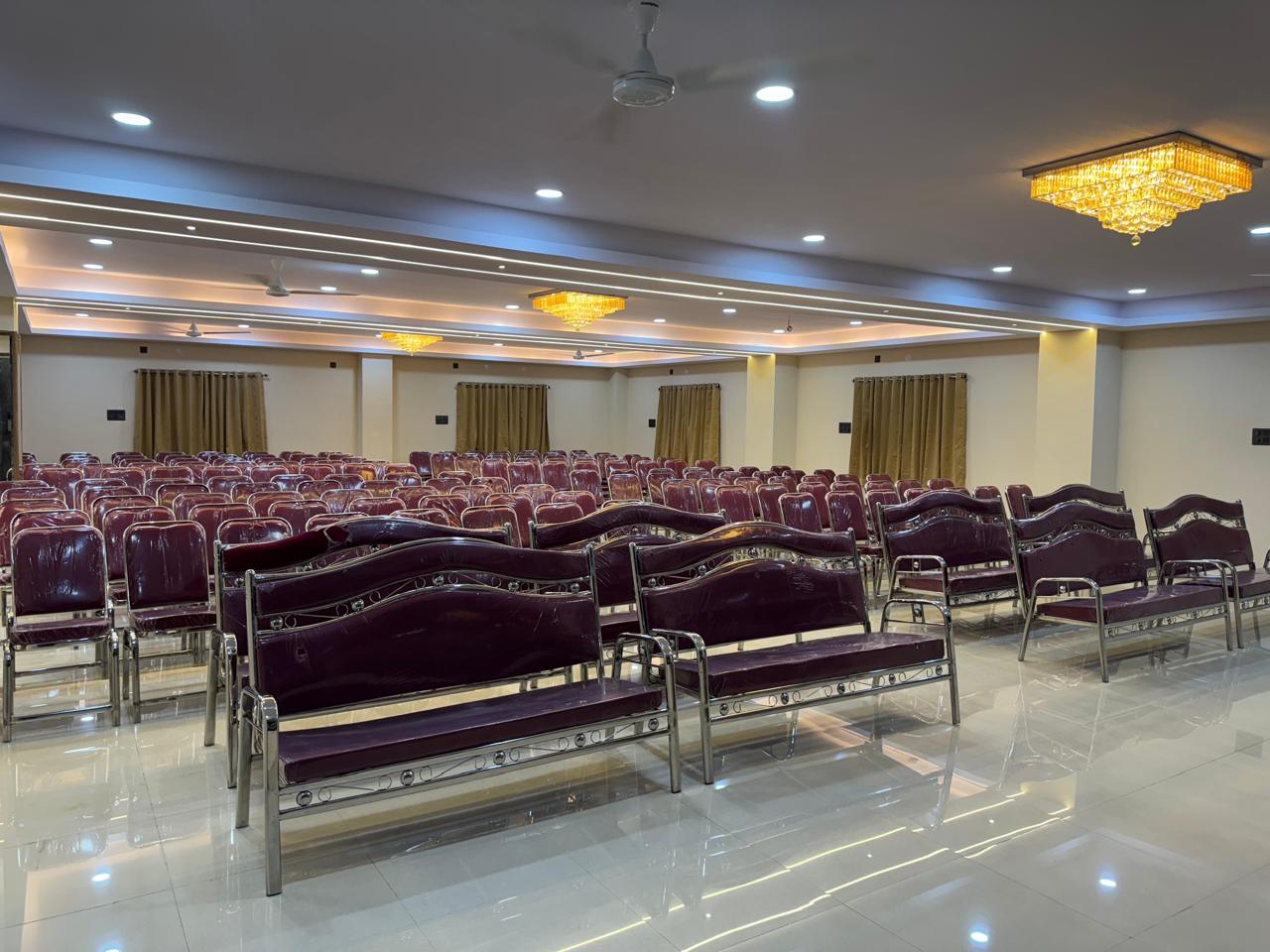 A spacious and elegant banquet hall at Raaj Hotel in Hyderabad, suitable for various events.