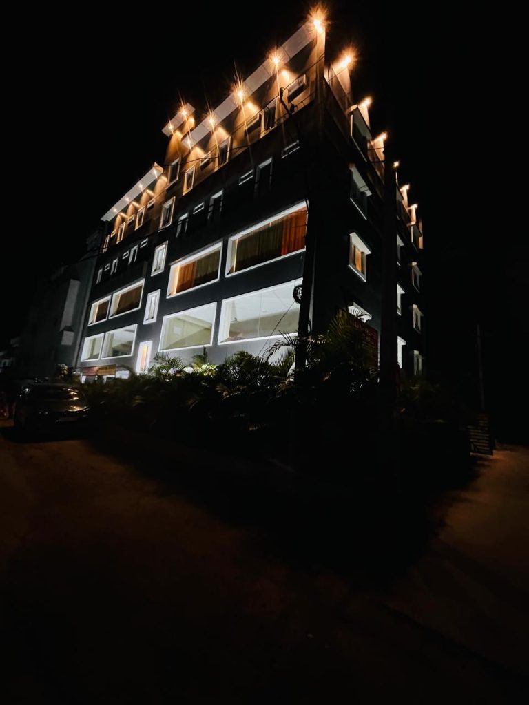 The illuminated exterior of Raaj Hotel in Nacharam, Hyderabad at night.