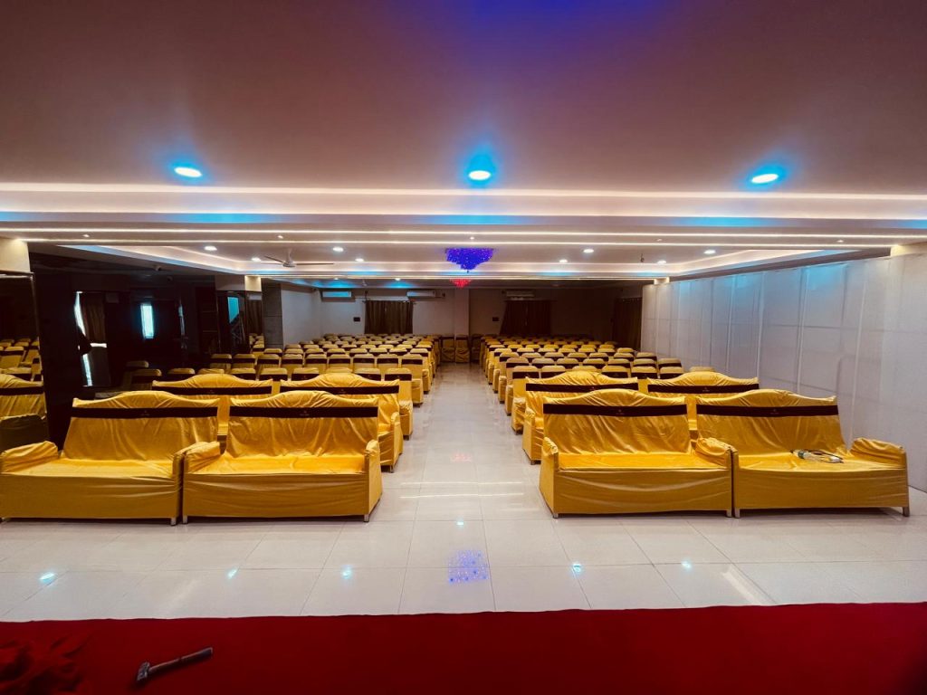 View from the back of an event hall in Mallapur's Raaj Hotel, showing seating arrangements.